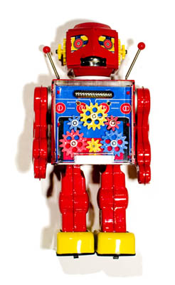 A classic sixties-era retro-style diecast metal toy robot, with visible gears in its chest cavity